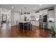 Spacious kitchen featuring a large island, stainless steel appliances, and hardwood floors at 802 Knollwood Dr, Apex, NC 27502
