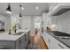 Bright kitchen with stainless appliances, gas range, island with sink and views to dining area at 802 Knollwood Dr, Apex, NC 27502