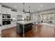 Spacious open-plan kitchen with seating at the island and views of the porch at 802 Knollwood Dr, Apex, NC 27502