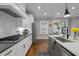 Modern kitchen featuring stainless appliances, gas range, subway tile backsplash, and sink at 802 Knollwood Dr, Apex, NC 27502
