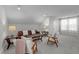Bright living room featuring a leather sofa, modern furniture, and large windows at 802 Knollwood Dr, Apex, NC 27502