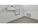 Finished attic space with window and AC, offering extra room for storage or a hobby area at 803 Driftwood Dr, Gibsonville, NC 27249