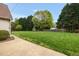 Expansive, well-manicured backyard with lush green lawn, mature trees, and room for outdoor activities at 803 Driftwood Dr, Gibsonville, NC 27249