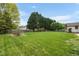 Large, green backyard featuring mature trees and landscaping providing a private and serene outdoor space at 803 Driftwood Dr, Gibsonville, NC 27249