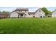 Spacious backyard featuring well-maintained lawn and mature trees, providing a peaceful and private setting at 803 Driftwood Dr, Gibsonville, NC 27249