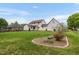Expansive backyard featuring lush green lawn, mature trees, and landscaping for outdoor enjoyment at 803 Driftwood Dr, Gibsonville, NC 27249