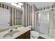Bathroom featuring a shower with glass doors and a large mirror above the sink at 803 Driftwood Dr, Gibsonville, NC 27249