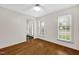 Sunlit bedroom with hardwood flooring, ceiling fan, and a view of the front door at 803 Driftwood Dr, Gibsonville, NC 27249