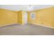 Sunny bedroom with neutral carpet, a white door, and a bright window at 803 Driftwood Dr, Gibsonville, NC 27249