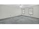 Spacious bedroom with two windows, ceiling fan, and neutral carpet; ready for your personal touch at 803 Driftwood Dr, Gibsonville, NC 27249