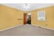Bright bedroom with neutral carpet and glimpses of the eat-in kitchen at 803 Driftwood Dr, Gibsonville, NC 27249