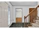 Inviting entryway with green-tiled floor, wood staircase, and view into the living room at 803 Driftwood Dr, Gibsonville, NC 27249