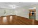 Bright living room featuring hardwood floors and a glimpse into the eat-in kitchen at 803 Driftwood Dr, Gibsonville, NC 27249
