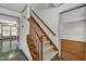 Traditional staircase with carpeted steps, wood railings, and view of hardwood floors at 803 Driftwood Dr, Gibsonville, NC 27249