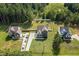 Aerial view of homes with spacious green lawns, fenced yard, and long driveway at 810 Mulberry Rd, Spring Hope, NC 27882