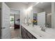 Bathroom featuring double sink vanity with granite countertop and modern fixtures at 810 Mulberry Rd, Spring Hope, NC 27882