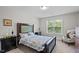 Bedroom with floral bedding, neutral walls, and natural light from a window at 810 Mulberry Rd, Spring Hope, NC 27882