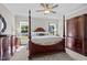 Spacious bedroom with a four-poster bed, dresser, and ample natural light at 810 Mulberry Rd, Spring Hope, NC 27882