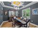 Formal dining room featuring a coffered ceiling, modern chandelier, and a large window with natural light at 810 Mulberry Rd, Spring Hope, NC 27882