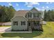 Charming two-story home with gray siding, a cozy front porch, and landscaped front yard at 810 Mulberry Rd, Spring Hope, NC 27882