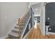 Hallway with wood floors, gray walls, white trim and staircase to the upper floor at 810 Mulberry Rd, Spring Hope, NC 27882