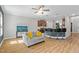 Living room with a ceiling fan, hardwood floors, and view of kitchen bar at 810 Mulberry Rd, Spring Hope, NC 27882