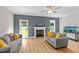 Living room showcasing wood floors, a fireplace, and a large window offering lots of light at 810 Mulberry Rd, Spring Hope, NC 27882