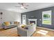 Bright living room with hardwood floors, a fireplace, and large windows that let in plenty of natural light at 810 Mulberry Rd, Spring Hope, NC 27882