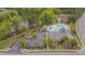 Aerial view of community pool, clubhouse, parking lot, and surrounding greenery at 900 Ambergate Sta, Apex, NC 27502
