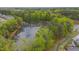 Aerial view of community with pond, surrounding lush greenery, and trees in view at 900 Ambergate Sta, Apex, NC 27502