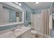 Bright bathroom featuring vanity with large mirror, shower-tub combination with light blue walls at 900 Ambergate Sta, Apex, NC 27502