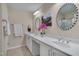 Well-lit bathroom features double sinks, white countertops, and stylish fixtures with an oval mirror at 900 Ambergate Sta, Apex, NC 27502