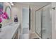Modern bathroom showcases a glass-enclosed shower, white vanity, and well-lit space with a neutral color palette at 900 Ambergate Sta, Apex, NC 27502