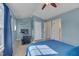 Cozy bedroom features neutral carpeting, blue walls, a ceiling fan, and a comfortable bed at 900 Ambergate Sta, Apex, NC 27502
