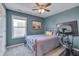 A well-lit bedroom showcases a plush bed, ceiling fan, framed artwork, and comfortable carpeting at 900 Ambergate Sta, Apex, NC 27502