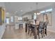 Bright dining area features a modern table set, stylish lighting, and connects seamlessly to the adjacent kitchen and living room at 900 Ambergate Sta, Apex, NC 27502