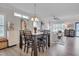 Dining area flows into the living area and features a modern table set, and stylish lighting at 900 Ambergate Sta, Apex, NC 27502
