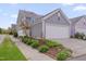 Exterior view of a modern home with a white garage door, landscaping, and a concrete driveway at 900 Ambergate Sta, Apex, NC 27502