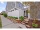 Exterior view showcasing walkway lined with lush greenery with steps to the entrance at 900 Ambergate Sta, Apex, NC 27502
