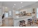 Modern kitchen featuring white cabinets, granite countertops, stainless steel appliances, and an eat-in bar area at 900 Ambergate Sta, Apex, NC 27502