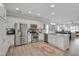 Bright, modern kitchen features stainless steel appliances, granite countertops, and an open design to living area at 900 Ambergate Sta, Apex, NC 27502