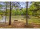 Scenic lake view with a bench, framed by trees, offering a peaceful and serene outdoor space at 900 Ambergate Sta, Apex, NC 27502