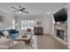 Bright and airy living space with modern furnishings, ceiling fan, fireplace, and views of the kitchen and dining area at 900 Ambergate Sta, Apex, NC 27502