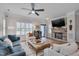 Beautifully decorated living room with stone fireplace, TV, hardwood floors, and comfortable seating arrangement at 900 Ambergate Sta, Apex, NC 27502