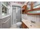Bathroom with oak vanity, and a tiled shower with glass doors at 926 Allister Rd, Durham, NC 27703