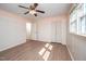 A light-filled bedroom featuring ceiling fan, modern floors, with a closet and ensuite bath at 926 Allister Rd, Durham, NC 27703