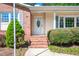Inviting front entrance with brick steps, an oval window door, and well-maintained landscaping at 926 Allister Rd, Durham, NC 27703