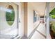 Close-up of front porch featuring a decorative glass door and adjacent shaded area with siding at 926 Allister Rd, Durham, NC 27703