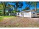 Detached garage with white siding, a large garage door, and a well-manicured lawn at 926 Allister Rd, Durham, NC 27703