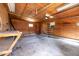 Spacious garage interior with plywood walls, concrete floor, and ample storage space at 926 Allister Rd, Durham, NC 27703